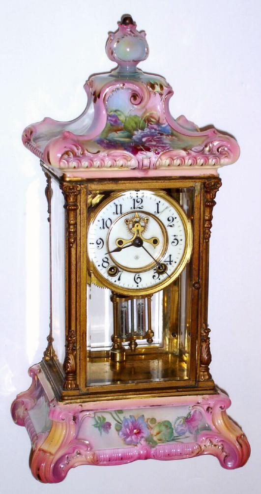 Ansonia Clock Co., Royal Bonn, CRYSTAL REGULATOR No. 3, in pink with yellow and lt blue accents and gold highlights + multi colored pansies, open 'scape on porcelain dial. — Antique Clocks Price Guide