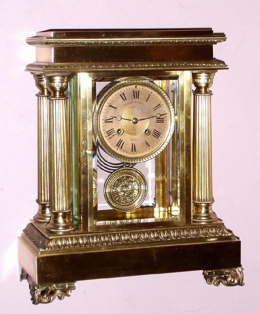 French, Japy Freres, C.1900, 4-Glass CRYSTAL REGULATOR, in a fancy brass Empire style case with 4 full columns, retailed by Bigelow, Kennard and Co., Boston {signed on gilt / engine turned brass dial} moon hands. — Antique Clocks Price Guide