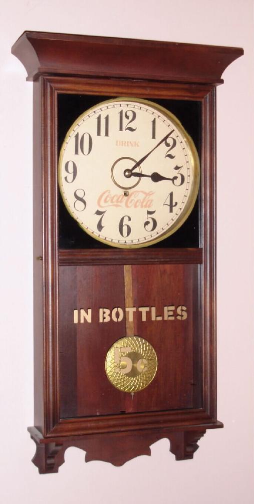 Gilbert "UNIVERSITY" hanging store regulator spring driven time only with 12" Arabic numeral paper over gilt pan dial in polished mahogany case, c1913 — Antique Clocks Price Guide
