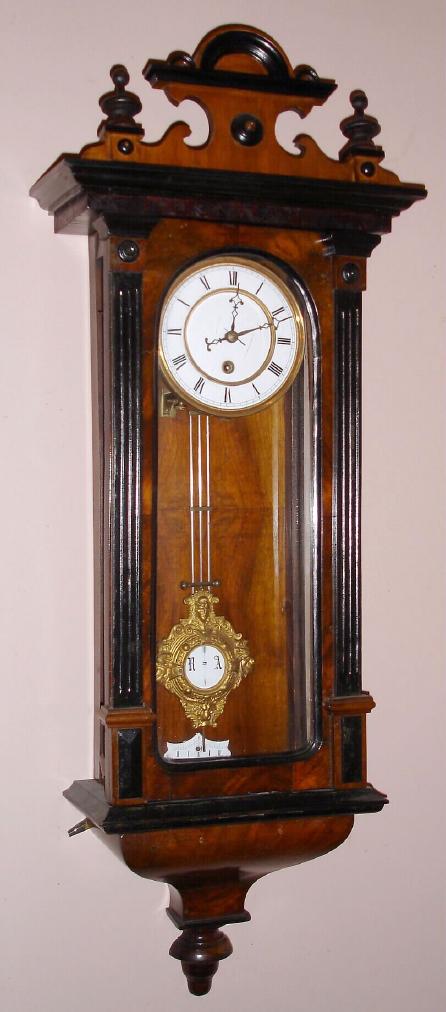 German, C.1875, Wall regulator, 8-day time, spring movt, with fancy cast and gilt R-A pendulum, and porcelain dial, walnut case. — Antique Clocks Price Guide