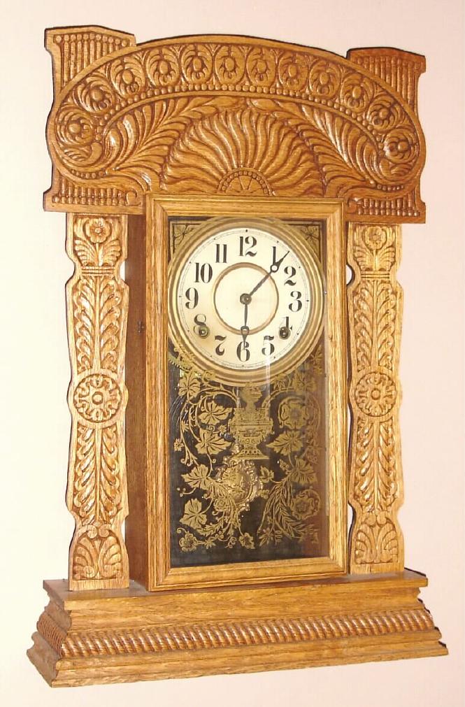 E. Ingraham Co., Bristol Conn. "ATLANTIC" model gingerbread clock from Ingraham's Ocean Line series 8 day time and half hour strike spring driven mvt in oak case with Arabic numeral gilt pan 6" dial, c1915 — Antique Clocks Price Guide