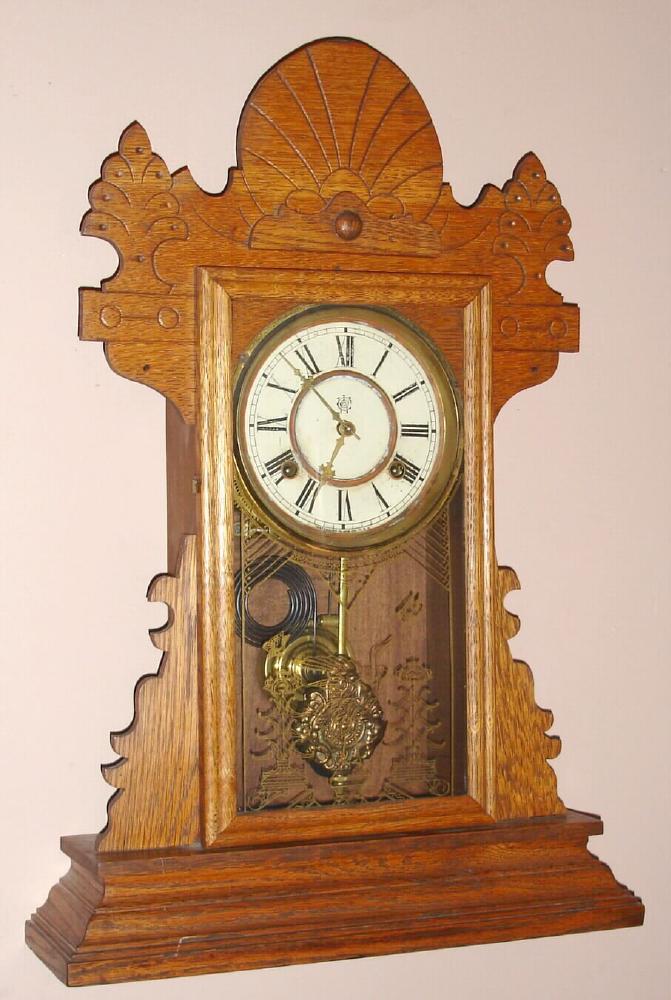 Waterbury Clock Co., Waterbury Conn. "FISHKILL" model 8 day time and strike spring driven mvt in oak case with gilt pan dial, c1890 — Antique Clocks Price Guide