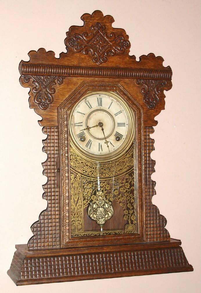 The E. Ingraham Clock Co., Bristol, Conn. "GARNET" model 8 day, time and strike, spring driven mvt in walnut case with "basket weave" pressing and Roman numeral gilt brass dial pan 6" dial, c1895 — Antique Clocks Price Guide