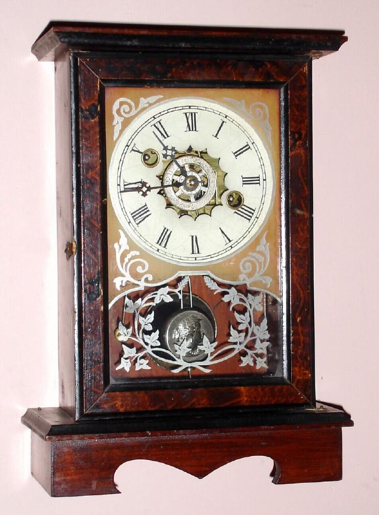 Wm. L. Gilbert Clock Co., Winsted, Conn. "BURL" model one day time and alarm spring driven movement in stained poplar case with grain painted door and Roman numeral painted zinc 4" dial, c1881 — Antique Clocks Price Guide