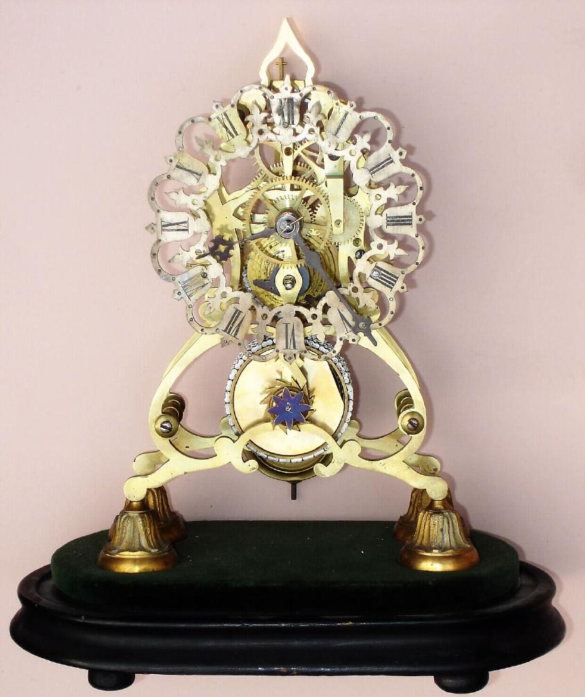 English, London area, timepiece skeleton clock, single chain fusee, in a scroll frame with well shaped baluster pillars, and w/ a well fretted brass and silvered dial, C.1860, less dome. — Antique Clocks Price Guide
