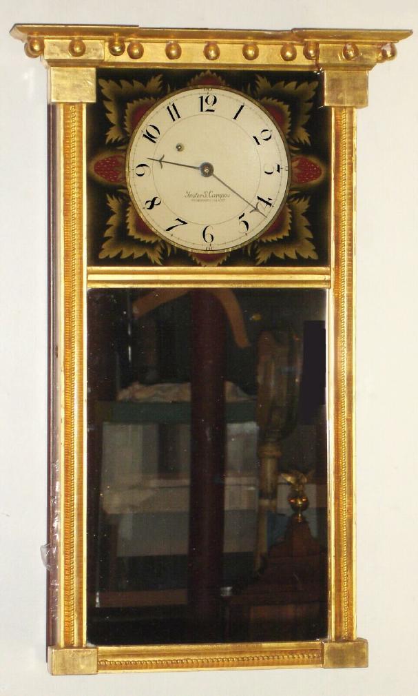 Foster S. Campos, Pembroke, Mass, N.H. MIRROR CLOCK, Miniature Federal style, copy of a Morrill original; note unusual shape of weight in order to achieve a week's duration, also using Kilbourne and Proctors wheel-barrow movement [signed]. Case dated 1981. — Antique Clocks Price Guide