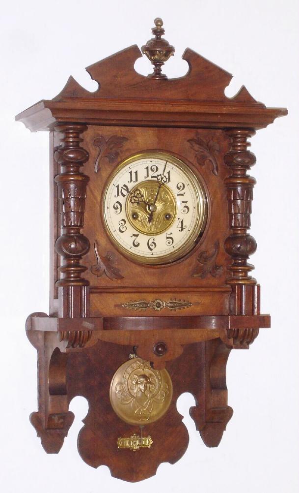German, Gustav Becker (Silesia), open well or Berlin style wall clock in walnut, with "cello" covered dial and a replacement top, C1900. — Antique Clocks Price Guide