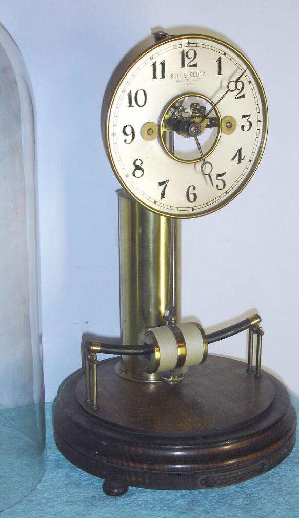 French, Model 100 "Bulle Dome", battery power, C.1925, designed by Maurice Phillipe Favre-Bulle in 1920, with original glass dome, and with retailers brass label: Cie. des Appareils Horo-Electrique, Boulogne s/ Seine — Antique Clocks Price Guide