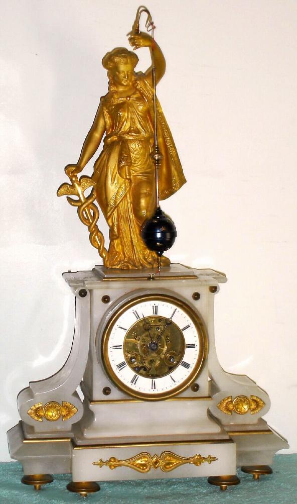 French gilt figural mantel clock with conical pendulum 8 day time and strike spring driven movement in soft white marble case surmounted by Greek figure holding pendulum, possibly Hygieia the goddess of good health, bearing a serpent entwined staff with Roman numeral porcelain chapter ring and exposed movement, sNo. 70867 c1850 — Antique Clocks Price Guide