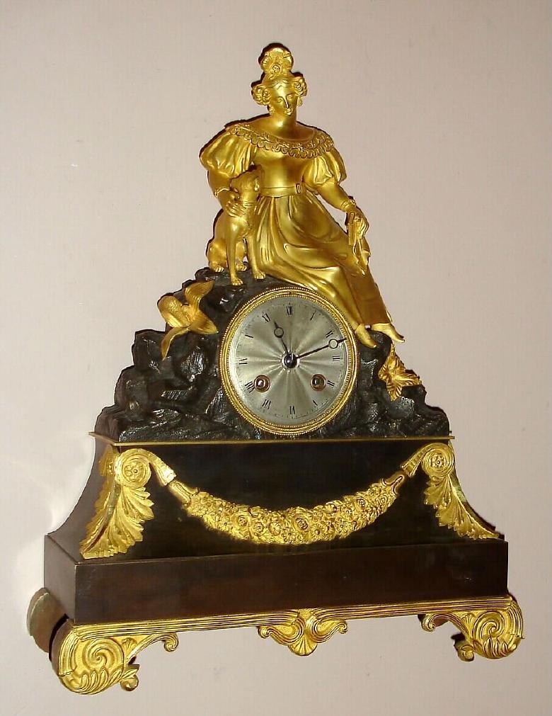French gilded brass figural mantel clock time and strike silk thread suspension spring driven movement with gilded lady petting her dog seated atop bronze base decorated with gilded trim on gilded brass feet with engine turned silvered 3" dial and Breguet style moon hands, c1840, mvt marked with an "M" and "4976" — Antique Clocks Price Guide