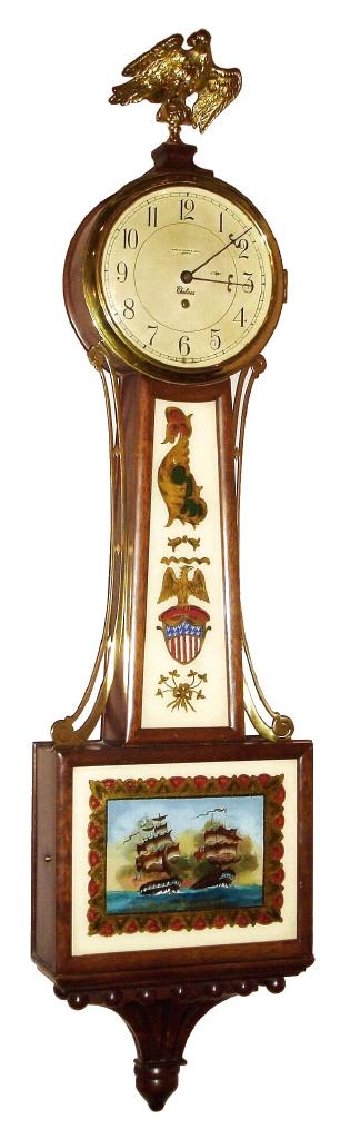 Chelsea Clock Co. 8 day spring driven banjo or patent timepiece retailed by Shreve, Crump and Low, Boston in mahogany case with lower tablet picturing a scene of the War of 1812 battle between the Constitution and the British Guerriere and gilded brass eagle finial, c1948 sNo. 552248 — Antique Clocks Price Guide