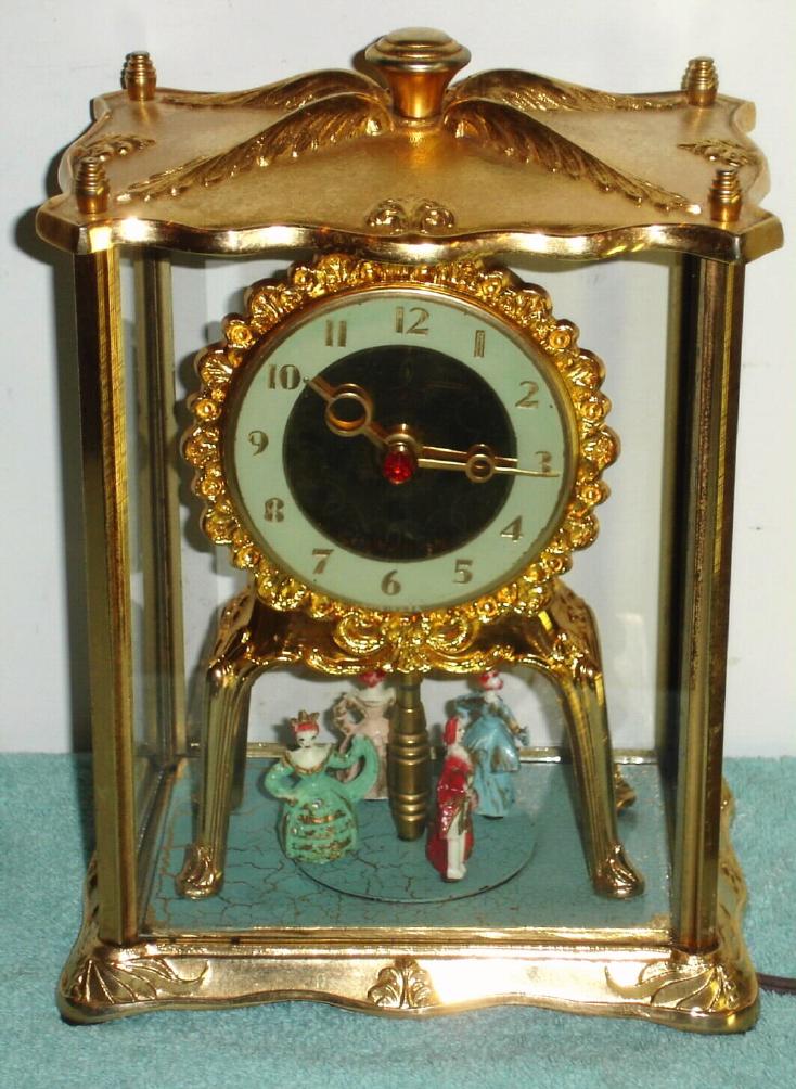 UNITED CLOCK CO.: Brooklyn, N.Y., 379 De Kalb Ave., C.1940. Model 990, 4-glass "regulator" with little plastic dancers in French attire, dancing around in a circle. 110v, w/ original cord — Antique Clocks Price Guide
