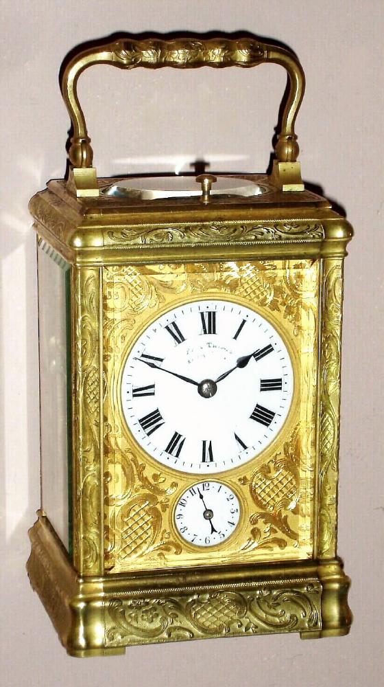 French, carriage clock, half hour strike with quarter hour repeat at will and with alarm, 8 day spring driven movement with platform lever escapement in a Gorge case, with profuse Rococo patterns cast and embossed into the mask and exterior surfaces. with Roman numeral porcelain dial surrounded by fancy gilt mask, c1900 — Antique Clocks Price Guide