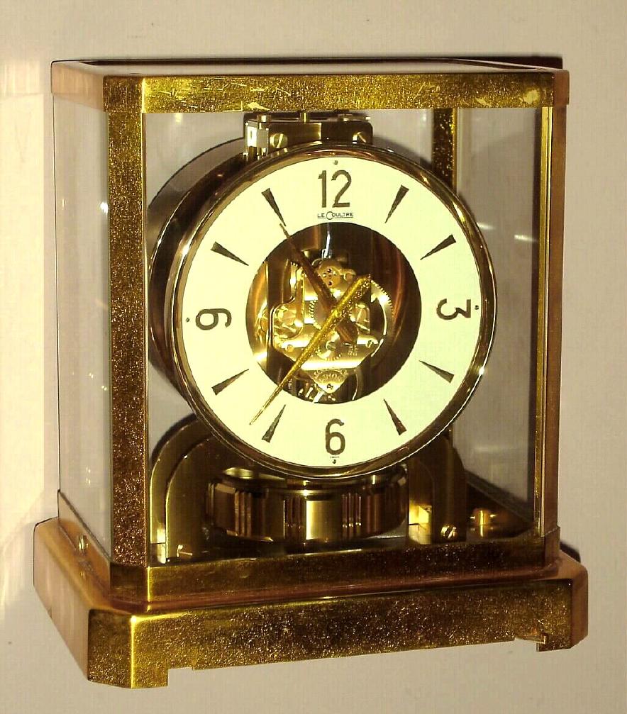 LeCoultre "ATMOS" perpetual running clock 15 jewels, wound by changes in temperature and pressure, mov't visible through gilt brass and glass case; sNo. 112604 c1958 — Antique Clocks Price Guide