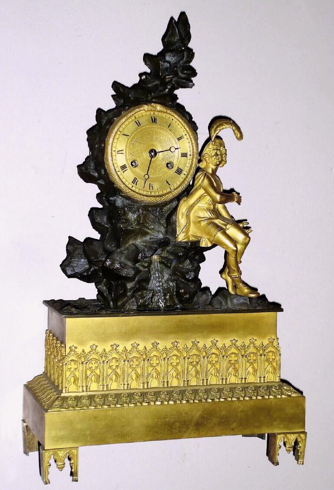 French gilded brass figural waterfall automaton mantel clock with 8 day time and bell strike silk thread suspension spring driven movement with troubadour seated atop bronze rocky outcropping with crystal "waterfall / fountain" turning as clock ticks giving it the appearance of pouring down the rock surface, on gilded brass base with fancy feet and engine turned gilt Roman numeral 3 1/2" dial and Breguet style moon hands, c1840, mvt marked with "B.P. and F." and "3410" — Antique Clocks Price Guide