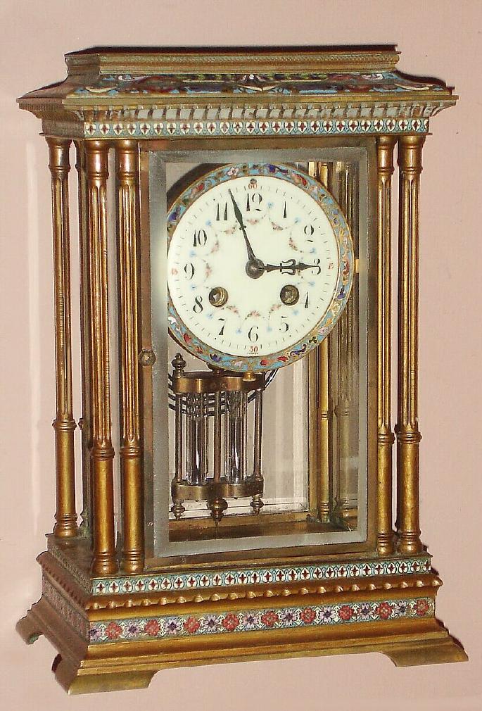 French, Marti et Cie, Circa 1900, 8-day time and gong strike brass and enamel crystal regulator mantel clock, w/ original 2-vial compensating pendulum; multi color enamel trim on case top, bottom and bezel, and with matching polychrome wreaths on the dial. — Antique Clocks Price Guide