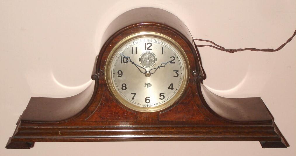 Sangamo Electric Co., Springfield, Ill., Circa 1928, An ingenious designed movement that uses jewel double-roller lever escapement from a 16 size Illinois pocket watch. The balance wheel is visible on the dial. An electric motor winds the movement in minute increments as needed and allowing the clock to run 30 hours if the electricity goes out. At the time the cycles per second had not been standardized and this clock still had to capacity to keep accurate time. — Antique Clocks Price Guide