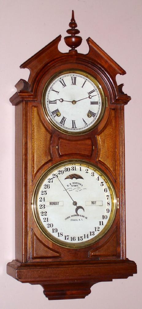 Ithaca Calendar Clock Co., No. 6, HANGING LIBRARY, double dial perpetual calendar clock in walnut, 8- day time and gong strike, C.1875 — Antique Clocks Price Guide