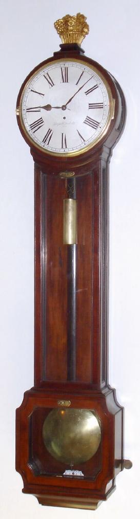 Austrian, Leopold Swoboda, Wien, early style wall regulator, {forerunner to the Latern style}, 1-wt timepiece, in a full length mahogany case with 10" silvered dial (meter pendulum), with curved side lights in the head and straight side lights in the narrow waist section, week duration, orig bone handled winding crank. — Antique Clocks Price Guide