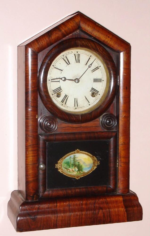 E. N. Welch, Forestville, Conn, an uncommon "Italian" style gothic clock; seems to have the outer dimensions of a Peerless, but the door of an Italian; we do not find this model in the Welch catalog, however it has a very good label is definitely orginal as shown. — Antique Clocks Price Guide