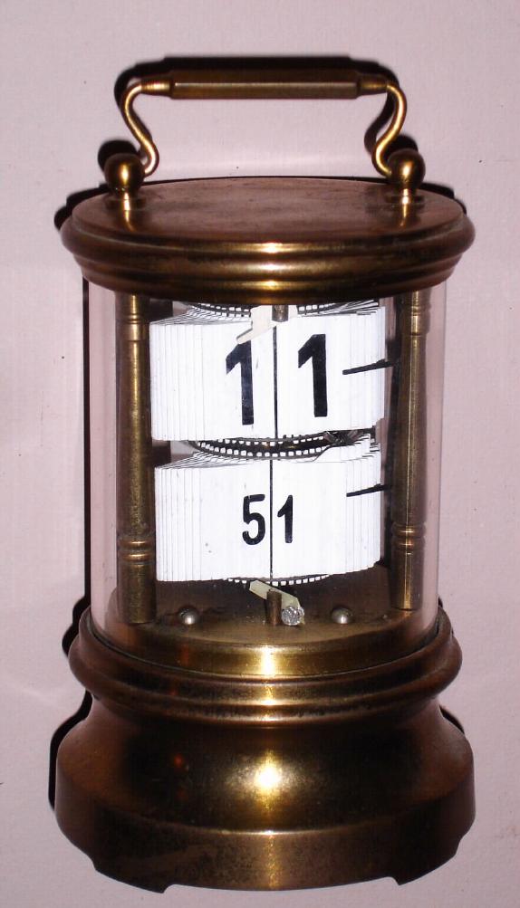 Ansonia Clock Co., PLATO No. 1, digital novelty clock; the cental shaft rotates once per hour and the number plates are released as it turns. — Antique Clocks Price Guide