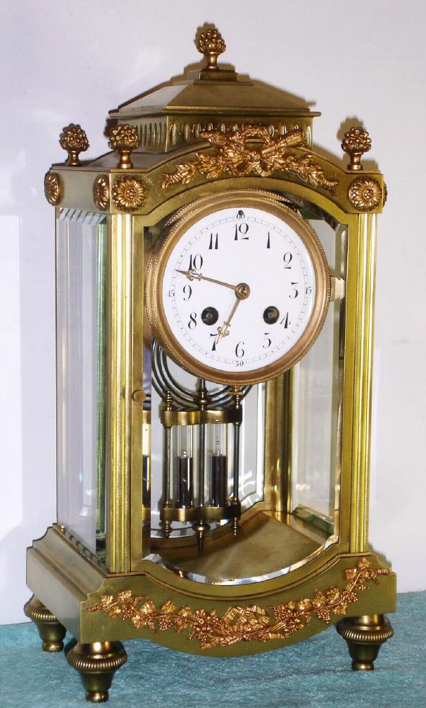 French, S. Marti and Cie, for Harris and Harrington-NY, 4-glass CRYSTAL REGULATOR, in a fancy pediment top case with cast berry finials and other applied scrolly trim, 8-day, gong strike, finely tooled gilt hands. — Antique Clocks Price Guide