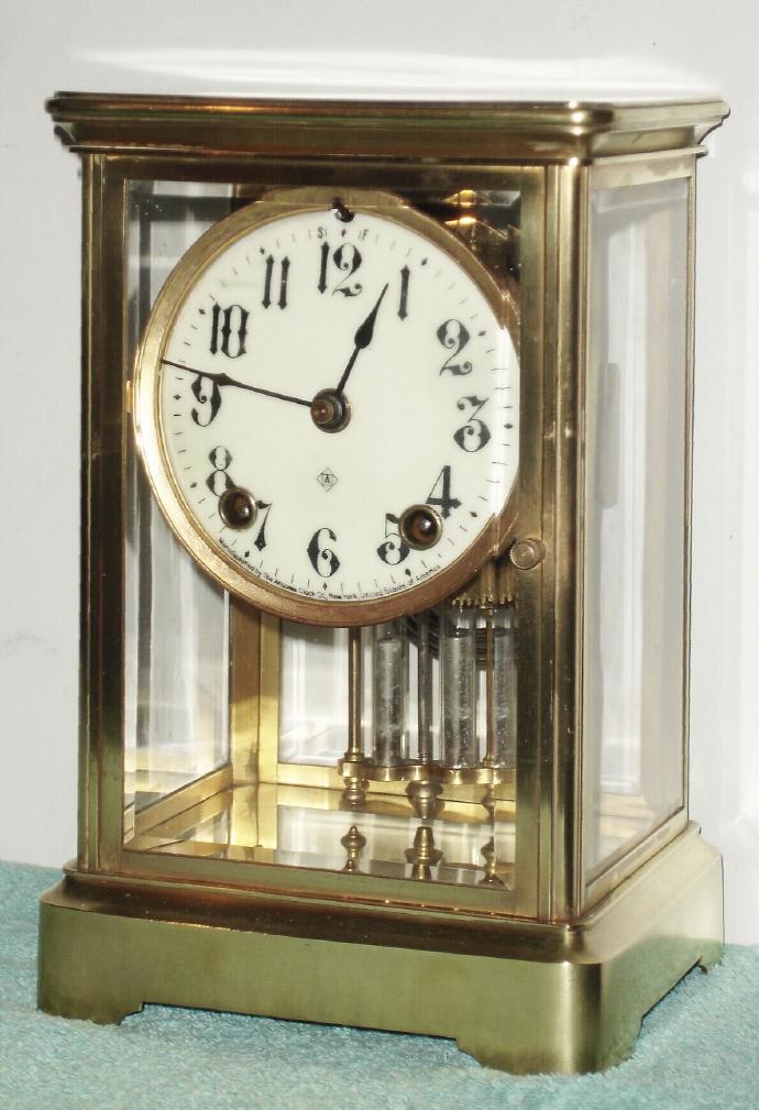 Ansonia Clock Co., CRYSTAL model 4-glass mantel regulator with 2-vial pendulum and solid creamy porcelain dial. — Antique Clocks Price Guide