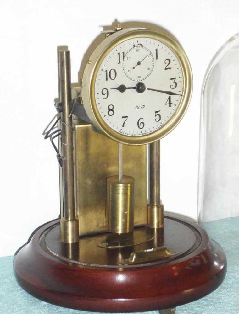 Barr Mfg Corp, Weedsport, NY, EXECUTIVE model, battery powered desk clock, with original glass dome. Note that Barr changed from a pancake style pendulum to a cylindrical style pendulum. — Antique Clocks Price Guide