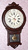 Wm. L. Gilbert, OFFICE DROP CALENDAR, C.1881, with Maranville type rotating disc simple calendar with month and days of the week, in a walnut case with carved trim and burled accents. Note Gilbert used paper discs, moved by a pointer, to evade the Maranville patent.