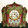 Ansonia Clock Co., C.1902, "DELTA" porcelain china cased clock, with 8-day, gong strike mov't with open escapement on porcelain dial. Colors are rust and green with fancy painted pattern below dial.