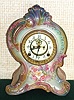 Ansonia Clock Co., C.1915, Royal Bonn, "LA FRANCE" porcelain china cased clock, with 8-day, gong strike mov't with open escapement on porcelain dial, in a multi-colored case, gray, blue and light aqua w/ pink accents, with multi colored floral decorations.