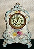 Ansonia Clock Co., C.1895, Royal Bonn, "LA CALLE" porcelain china cased clock, with 8-day, gong strike mov't with open escapement on porcelain dial, in white case with light blue accents and gold highlights.