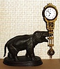 C.1910, German, Junghans, ELEPHANT swing clock, the clock contained in the gilded "arm" supported by his trunk, back wind, center set, and with porcelain dial, 8-day.