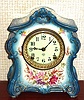 Ansonia Clock Co., C.1914, Royal Bonn, "LA FONTAINE" porcelain china cased clock, with 8-day, gong strike mov't with one piece porcelain dial, in a cream and blue case with multi colored floral decorations,