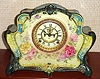 Ansonia Clock Co., C.1905, Royal Bonn, "LA RITA" porcelain china cased clock, with 8-day, gong strike mov't with open escapement on porcelain dial, in a multi-colored case, cream base, yellow and aqua accents to front, dark gray-green bottom and side trim, with varied color floral decorations.