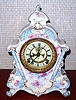 Ansonia Clock Co., C.1895, Royal Bonn, "No. 502" porcelain china cased clock, with 8-day, gong strike mov't with open escapement on porcelain dial, in a creamy case with light blue accents and small dark pink flowers.