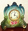 Ansonia Clock Co., C.1905, Royal Bonn, "LA CHAPELLE" porcelain china cased clock, with 8-day, gong strike mov't with one piece porcelain dial, in a multi-colored case, aqua at top, lime green center and dark green bottom, and with magenta colored blossoms below the dial.