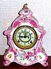 Ansonia Clock Co., C.1895, Royal Bonn, "No. 502" porcelain china cased clock, with 8-day, gong strike mov't, open escapement in the center of the 2-piece porcelain dial, and the case a wonderful pink color with matching floral accents and gold highlights.