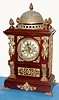 Ansonia Clock Co., "CABINET ANTIQUE, No. 1", sometimes called the bell top antique, in oak with brass plated metal trimmings, this clock with fancy brass dial with individual porcelain cartouche numerals, c.1894