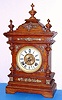 Ansonia Clock Co., "CABINET-A", in oak with brass trimmings, and with old finish. 8-day gong strike movement.