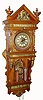 Ansonia Clock Co., "ANTIQUE - HANGING" in oak with brass trimmings, 2-weight chain drive, gong striking movement, and brass dial with individual porcelain cartouche numerals; hinged doors on sides for access to hang pendulum and set beat, c.1809