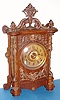 Ansonia Clock Co., "CABINET - B", oak cased clock with antique brass trimmings, 8-day gong strike mov't, and with embossed brass dial, c.1894