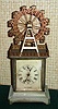 German, Hamburg American [crossed arrow trademark], C.1910, novelty with large Ferris wheel that goes 'round while the clock is running. This is a one day time and alarm, also with seconds hand.