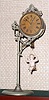 Ansonia Clock Co. New York, "JUMPER NO. 1", C.1896, movement held aloft by a single pole, nickel plated stand, the pin pallet movement released by the ceramic doll jumping up and down. Female doll in light pink.