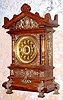 Ansonia Clock Co., New York, C.1894 "CABINET - C", antique oak cased mantle clock with brass trimmings. Has fancy embossed brass dial with raised Arabic numerals,