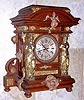 Ansonia Clock Co., New York, C.1894 "SENATOR", antique oak cased mantle clock with brass trimmings. Features full figured female columns on either side of the dial with other large and impressive brass plated bits. 8-day, time and gong striking.