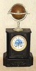 C.1890, French, Edouard Serin, World Time Globe, striking, with phases of the moon and with the name of the retailer, Gowland, Sunderland on the porcelain dial. Uses a unique bell strike movement, with drive mechanism turning at a 90 degree angle from the rear plate and extending up to drive the globe at top. The globe is signed Edouard Serin. There are 24 small porcelain cartouche around the brass ring at the equator.