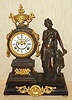 Ansonia Clock Co., New York, C.1880, "POETRY" figure clock, bronze patinated spelter statue and clock tower on a black iron base, with gilt ornaments. Open escapement on porcelain dial.