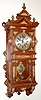 German, Lenzkirch, Walnut cased wall clock with profuse gilt bronze trim, 8-day spring movement, gong striking with extra fancy cast and chased baroque style pendulum with a silvered cherub in the center.