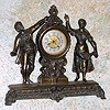 Ansonia Clock Co., New York, C.1900, "FROLIC" cast metal desk novelty, with 1-day rear wind mov't, with silvered brass dial and embossed floral dial center.